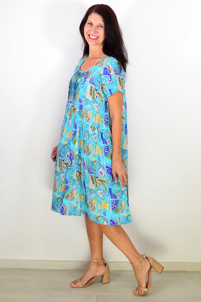 Hourglass Aqua Paisley floral pleated casual tunic dress with a relaxed fit and vibrant pattern, displayed on a mannequin.