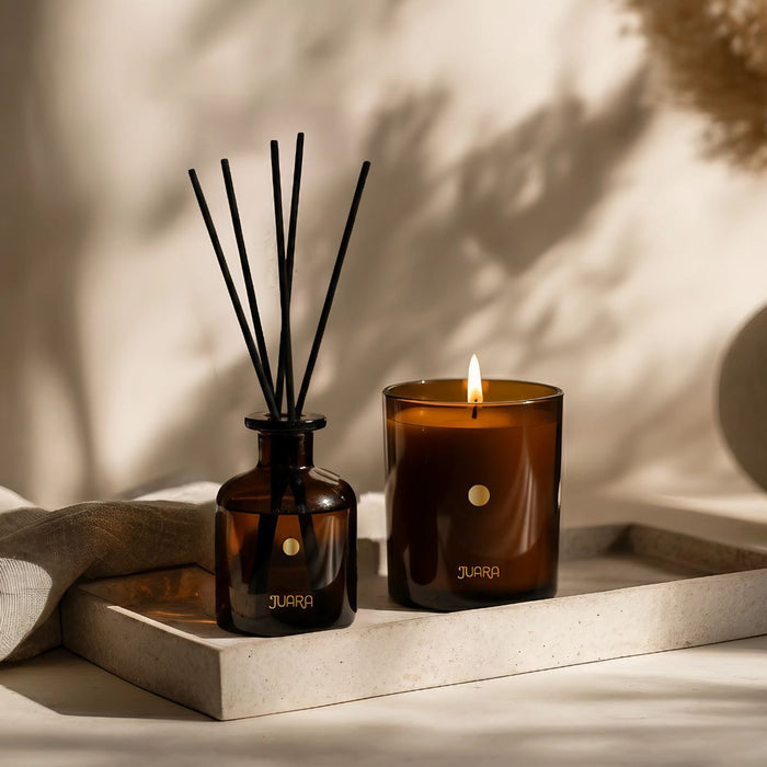 Brown candle diffuser set on a tray with a neutral background