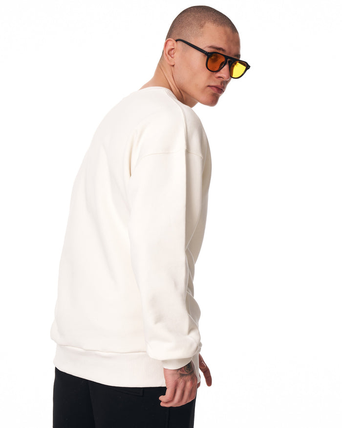 Martin Valen oversized men's white sweatshirt, three-quarter rear view on model, visible ribbed cuffs and hem