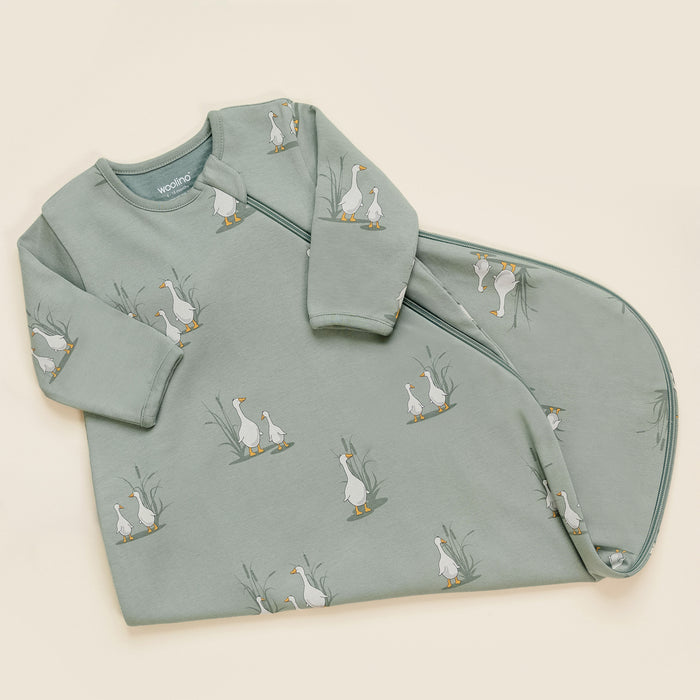 Children's sleep bag with a pattern of geese on a light green background, folded at the bottom half