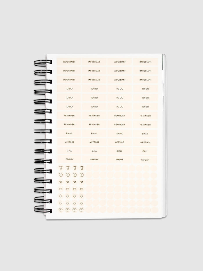 Planner Stickers in a 2022 Spiral Bound Planner on a neutral background