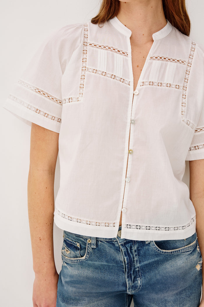 Alanis Shirt in Lightweight Cotton With Split Band V-Neckline, Front Button-and-Loop Closures, Lattice Embroidery, and Short Puff Sleeves in White Colorway - Upper Body Front View Featured on Model