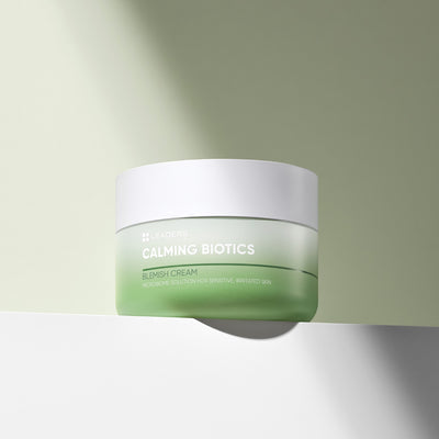 Calming Biotics Blemish Cream | Leaders in a green and white jar displayed on a soft green and white background, highlighting its skincare benefits.