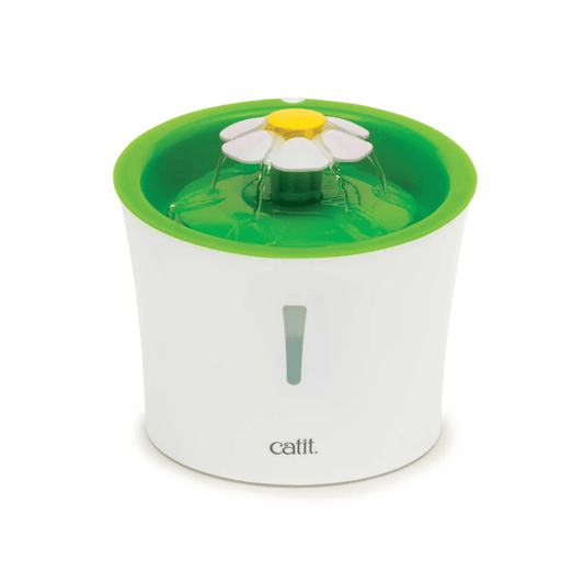 White background with a Catit water fountain for cats with a green top plate with a flower in the centre.