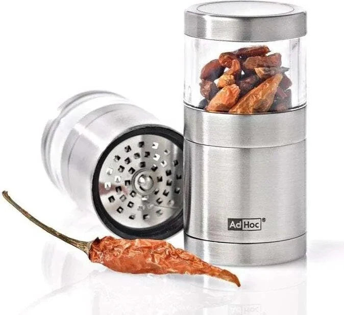 Stainless steel pepper grinder with pepper and Ad Hoc branding on a white background