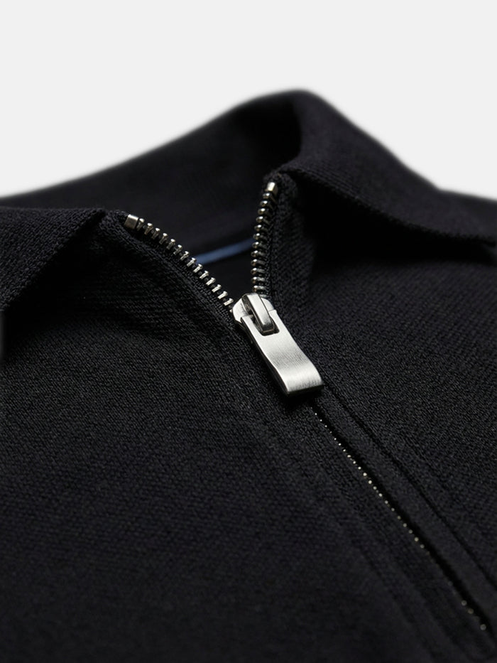 Close-up of black zip polo collar, textured cotton fabric detail for men