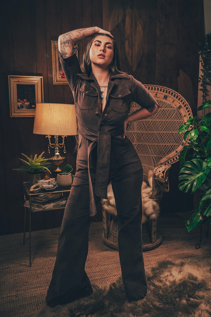 Full length chocolate corduroyed jumpsuit with bold colour fitted waist and flared legs styled for modern retro women's fashion