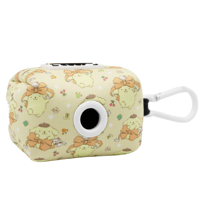 The Sassy Woof Dog Waste Bag Holder - Pompompurin™ is a small, rectangular beige neoprene holder with cute cartoon characters in brown hats and bows, tiny flowers, a circular opening, and a white clip for easy carrying.