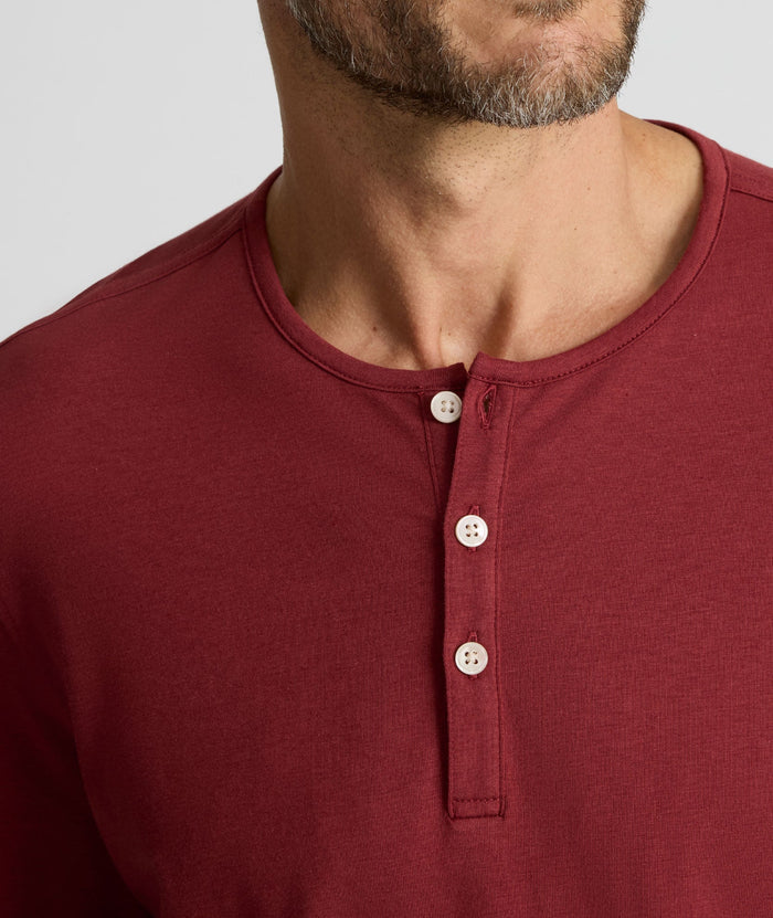 Model is wearing UNTUCKit EcoSoft Henley in Burgundy.