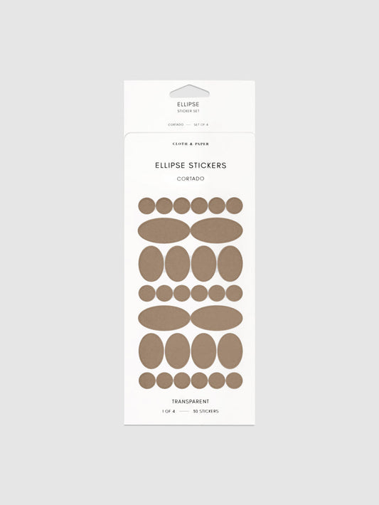 Cortado stickers in their packaging on a neutral background.