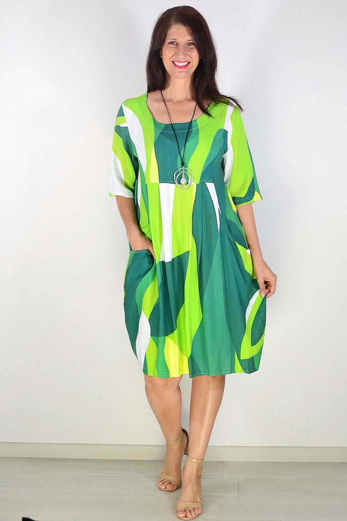Green and white abstract print tunic dress by Hourglass, featuring a relaxed fit and stylish design, shown on a model.