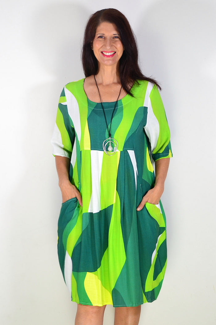 Hourglass green and white abstract print tunic dress featuring a relaxed fit and stylish design, shown on a model.