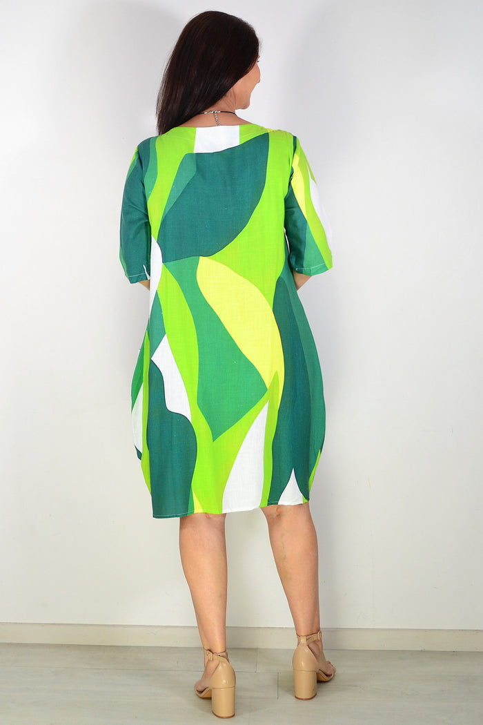 Hourglass green and white abstract print tunic dress displayed on a model showcasing its stylish and comfortable design.