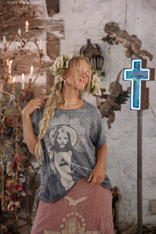 Woman in Magnolia Pearl artisan vintage t-shirt and skirt with whimsical floral crown, rustic setting