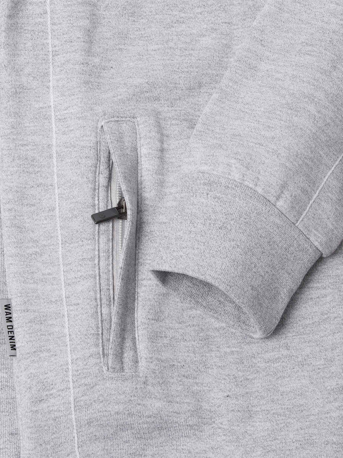 Close-up of The Fletcher Light Grey Vest pocket and cuff showing zip detail and label – Wam Denim.