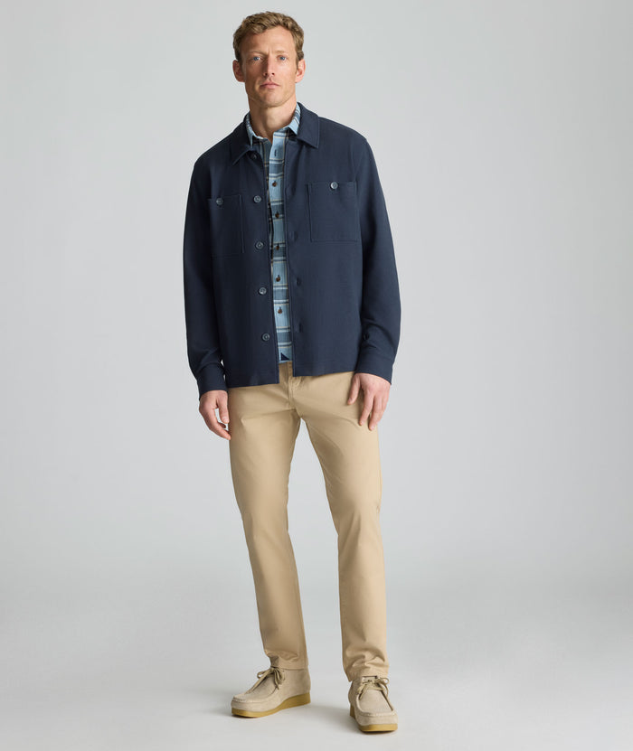 Model is wearing UNTUCKit Knit Overshirt in blue.