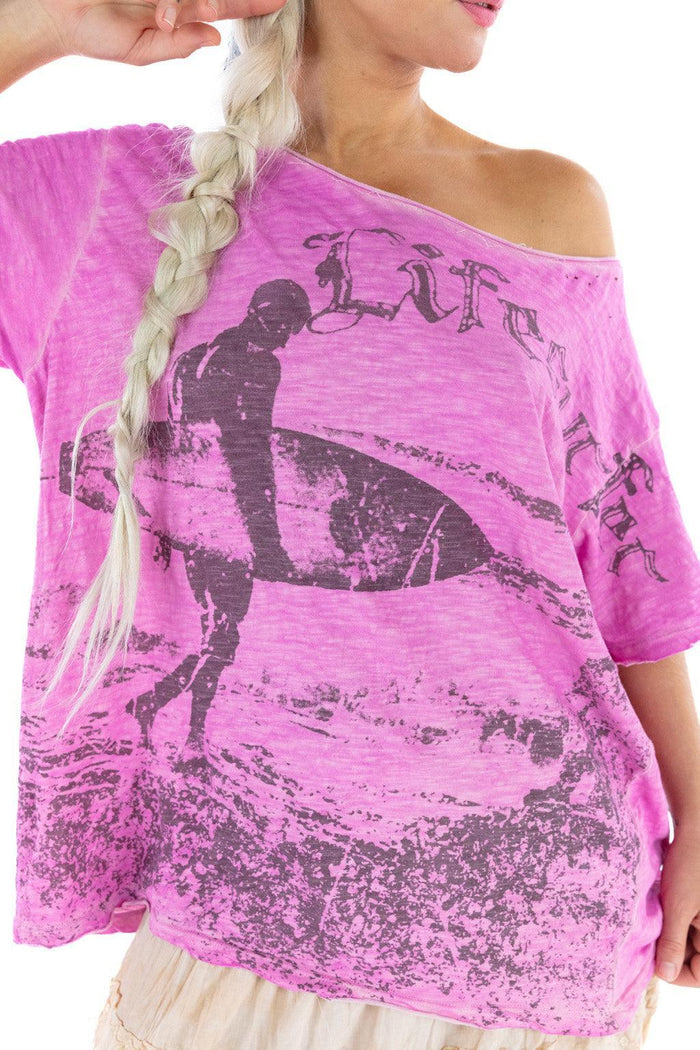 Magnolia Pearl pink oversized artisan tee with vintage surfer graphic, off-shoulder design