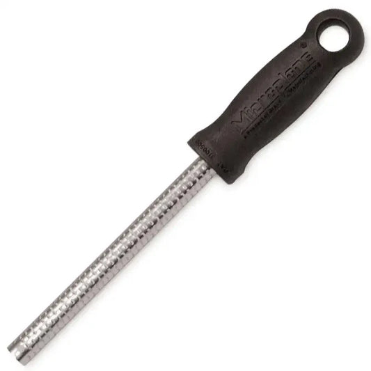 A Microplane Spice Grater with a black plastic handle and a silver surgical grade stainless steel blade.