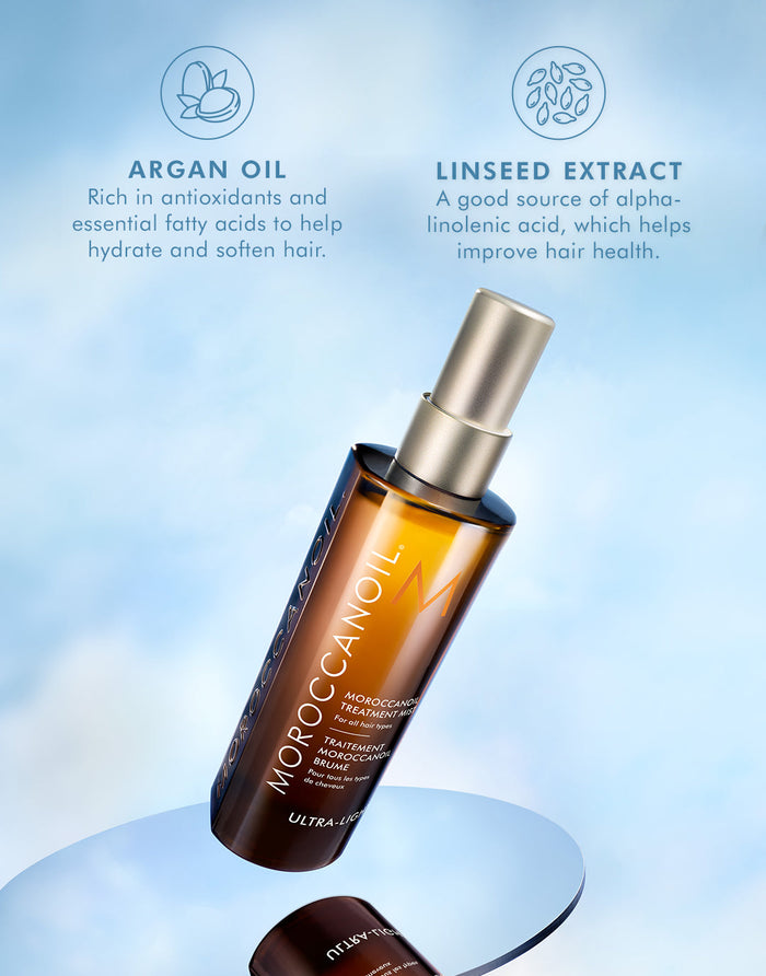 Bottle of Moroccanoil Treatment Mist - Full Size | Moroccanoil displayed on reflective surface with descriptions of key ingredients, argan oil and linseed extract, for hair hydration and health.