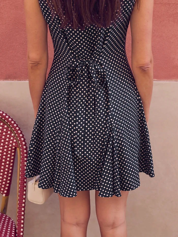 Navy polka dot mini dress with boat neckline, button-front placket