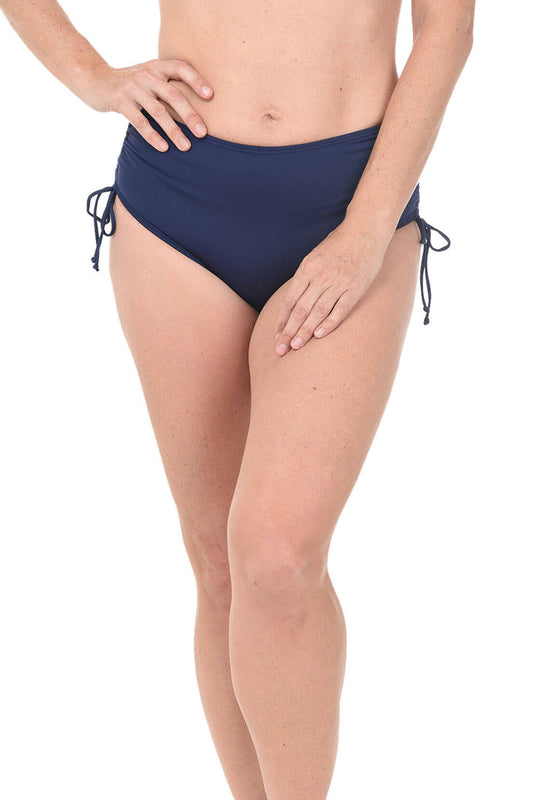 Navy blue bikini bottom worn by a person on a white background.