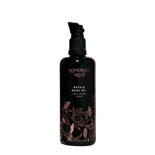 Bottle of Spring Summer Bath & Body Oil | Somerset Moss with floral design on black packaging, designed for skincare and body care wellness.