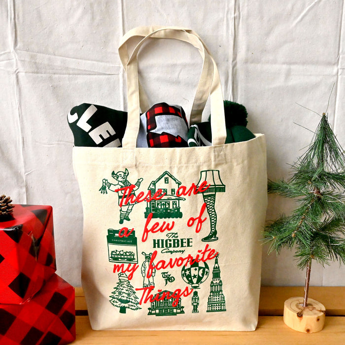 Beige tote bag with Christmas-themed design and text, filled with items, on a white background.