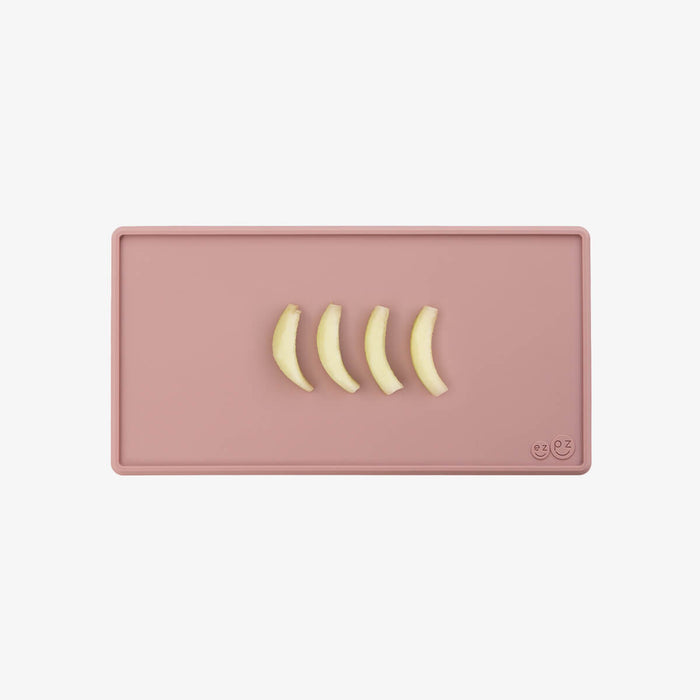 The Tiny Placemat in Blush is a non-slip, silicone placemat that fits on most highchair trays