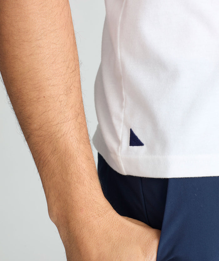 Model is wearing UNTUCKit saxum tee in white.