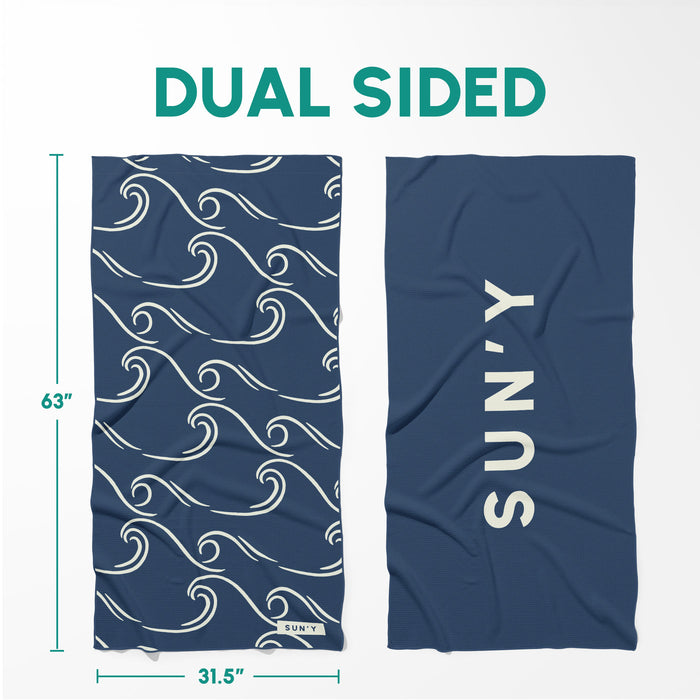Waffle Microfiber Beach Towel - Curl | SUN'Y showing dual-sided design with navy blue wave pattern on one side and solid navy blue with SUN'Y logo on the other side.