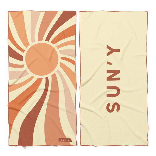 Waffle Microfiber Beach Towel - Rays | SUN'Y showing front with a sunburst pattern in warm tones and back with the SUN'Y logo on a light background.