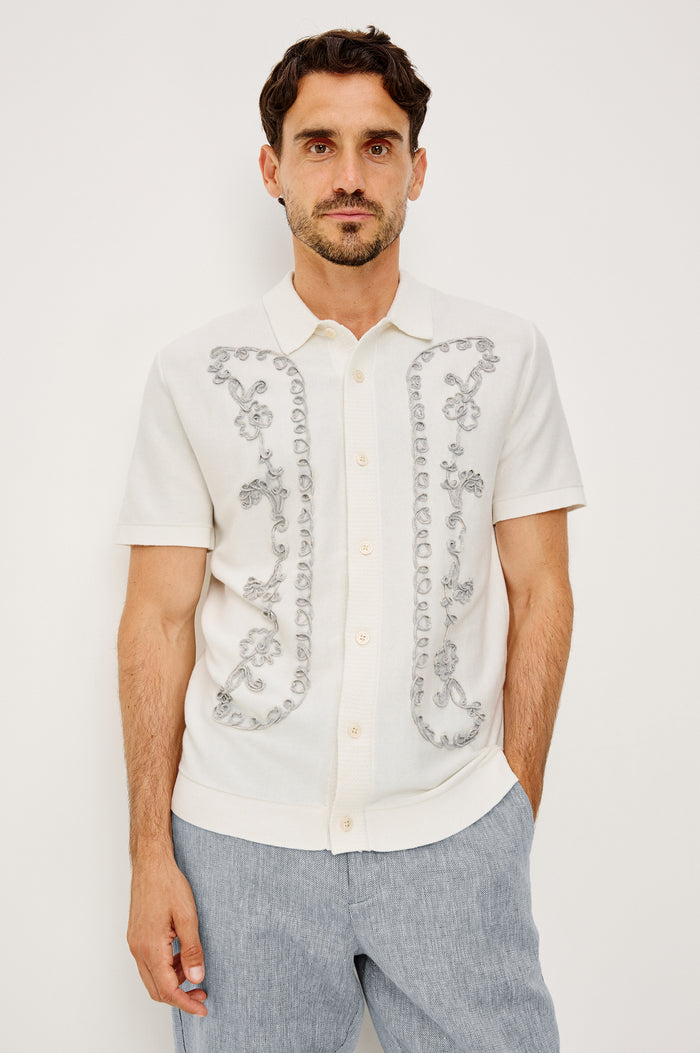 Walden Polo Shirt in Cotton Blend With Collar, Front Buttons, Full Needle Front Applique, and Classic Fit in White Oat Floral Colorway - Upper Body Front View Featured on Model